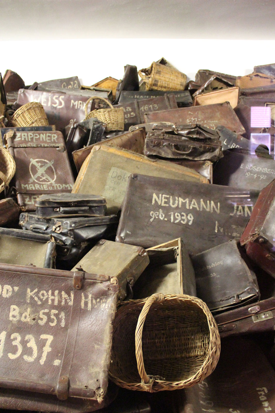 Pile of suitcases with names written on them