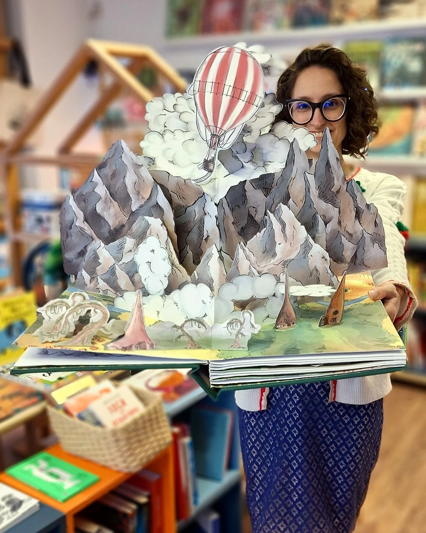 Sofia showing the pop-up book 'The story of Oz and the Wonderful Wizard: Replica Pop-Up book'