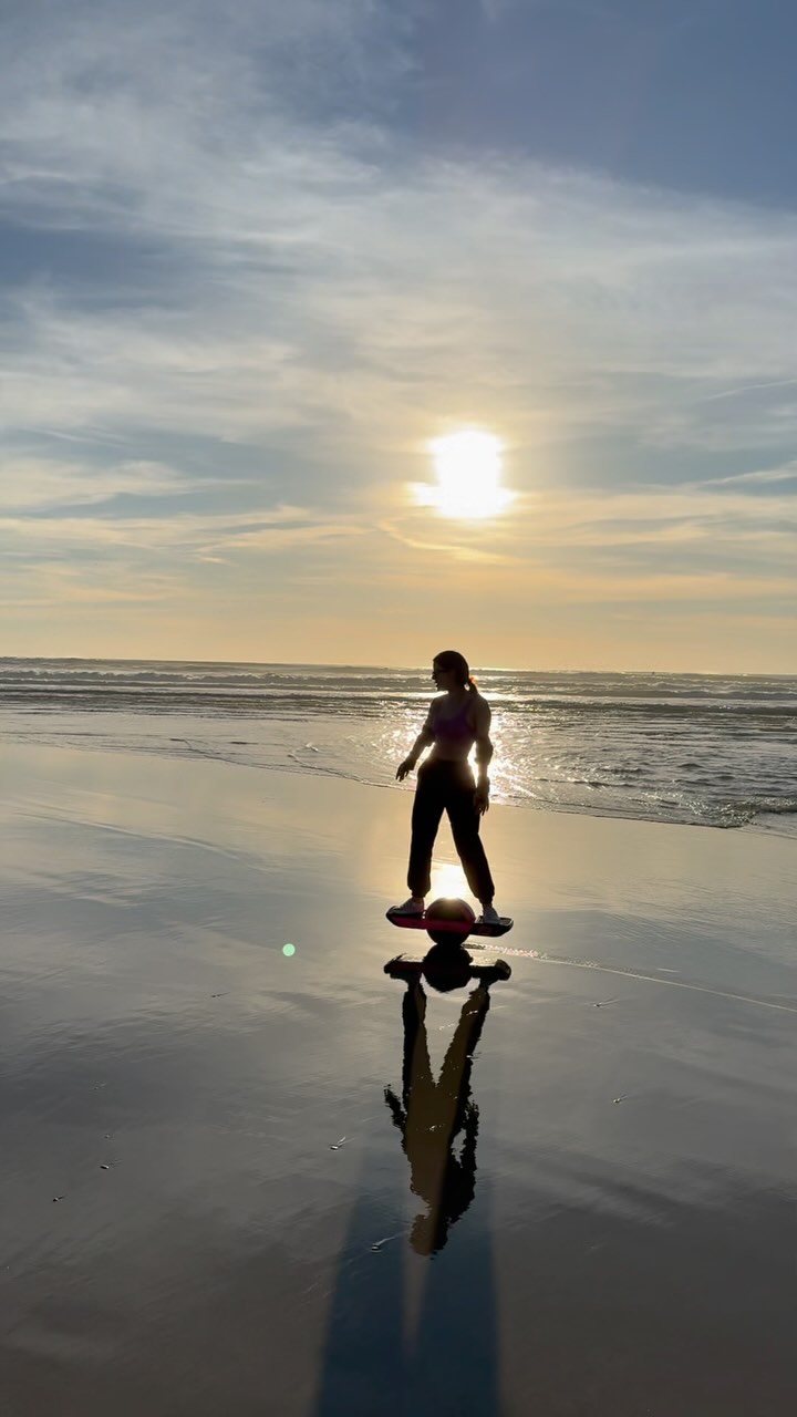 Riding a Onewheel in wet sand on beach
